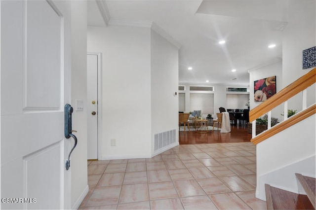 foyer entrance featuring crown molding