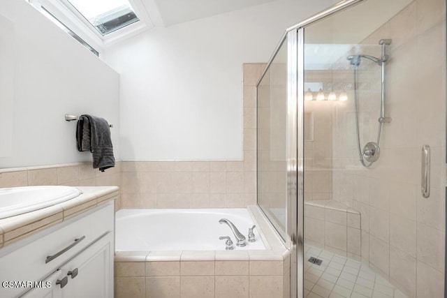 bathroom with vanity and separate shower and tub