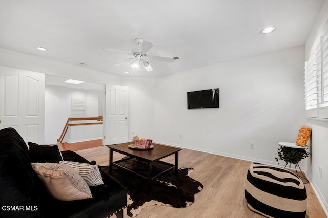 living room featuring ceiling fan and light wood-type flooring