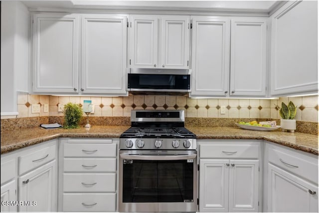 kitchen featuring stainless steel appliances, white cabinetry, tasteful backsplash, and stone counters