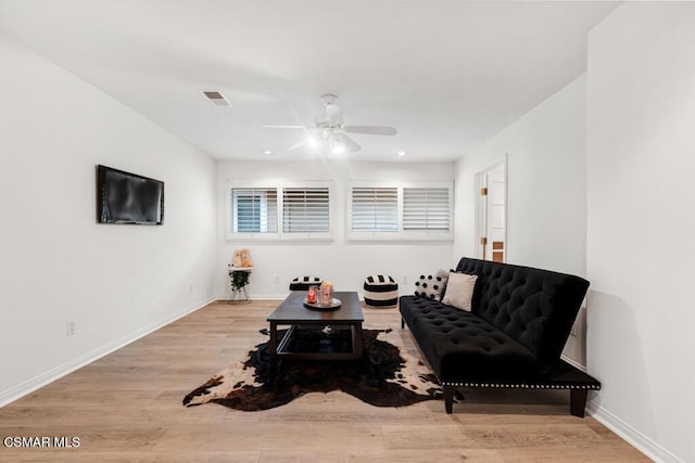 living area featuring ceiling fan and light wood-type flooring