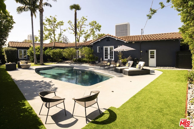 view of pool with a lawn, a patio area, and central air condition unit