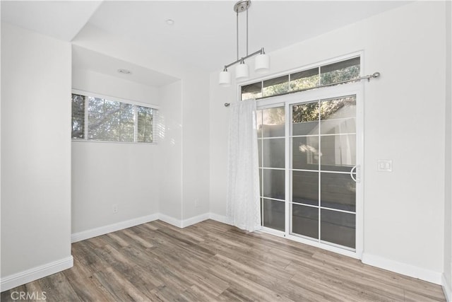 unfurnished dining area featuring hardwood / wood-style flooring and a wealth of natural light