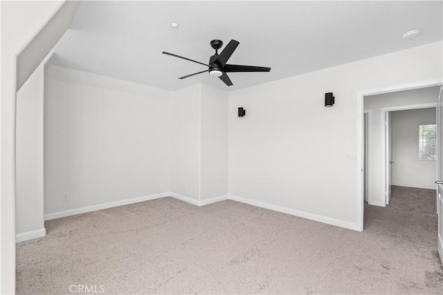 interior space featuring light colored carpet and ceiling fan