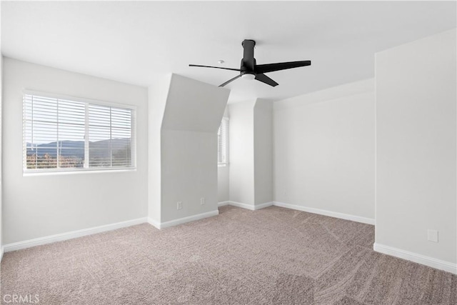 unfurnished room featuring ceiling fan and light carpet