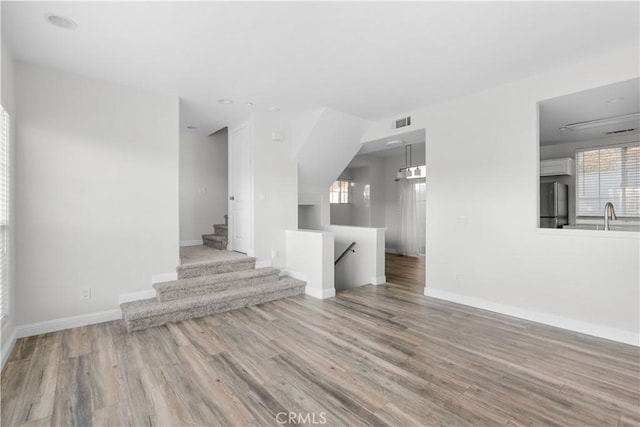 empty room featuring sink and light wood-type flooring