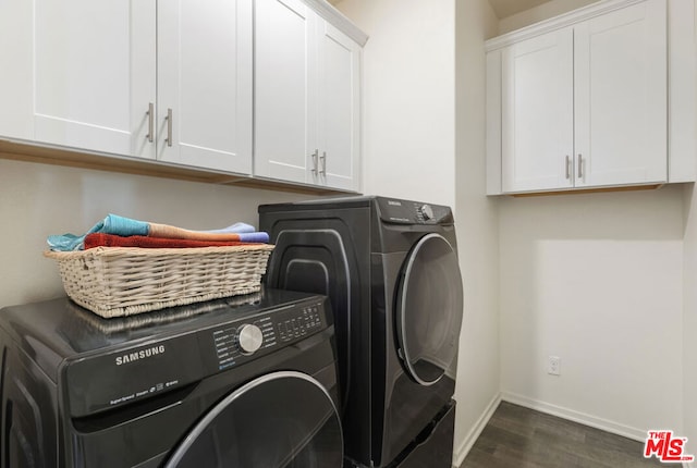 laundry room with dark wood-type flooring, cabinets, and separate washer and dryer