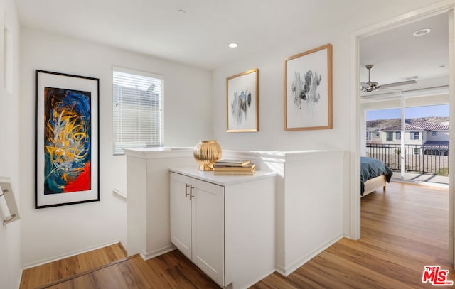 interior space featuring white cabinetry, light hardwood / wood-style floors, and ceiling fan