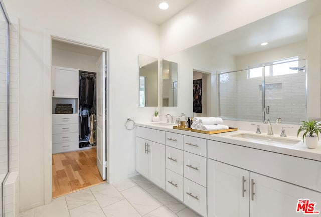 bathroom with an enclosed shower and vanity