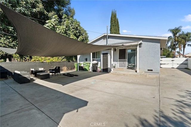 back of property with an outdoor hangout area and a patio area