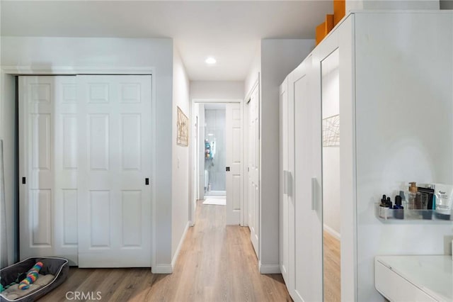 hallway with light hardwood / wood-style flooring