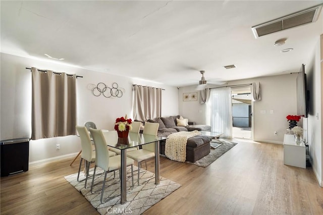 living room with ceiling fan and light wood-type flooring