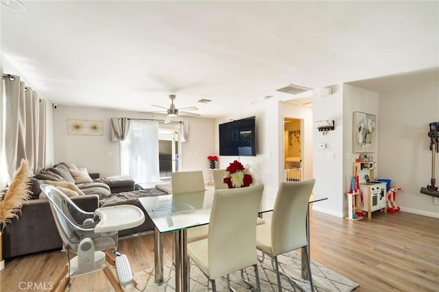 dining room with ceiling fan and light wood-type flooring