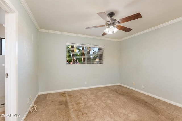 spare room featuring crown molding, ceiling fan, and light carpet