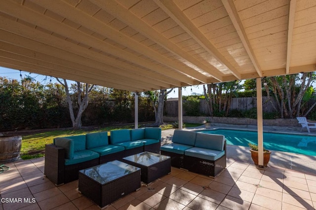 view of patio with an outdoor living space and a fenced in pool