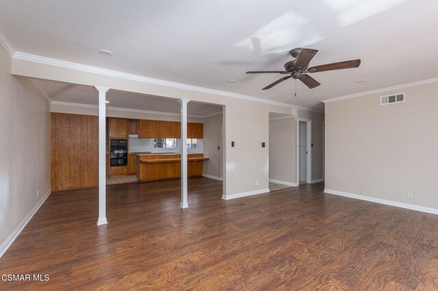 unfurnished living room featuring crown molding, decorative columns, and ceiling fan