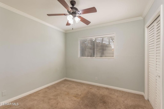 unfurnished bedroom featuring crown molding, light colored carpet, and ceiling fan