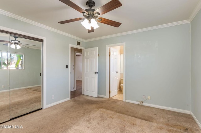 unfurnished bedroom with ceiling fan, ensuite bathroom, light colored carpet, and a closet