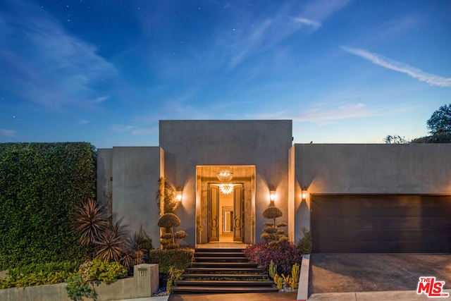 pueblo revival-style home featuring a garage