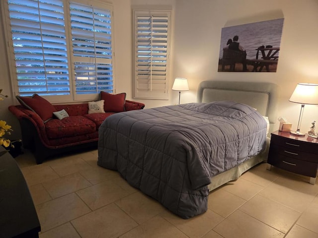 bedroom with light tile patterned floors