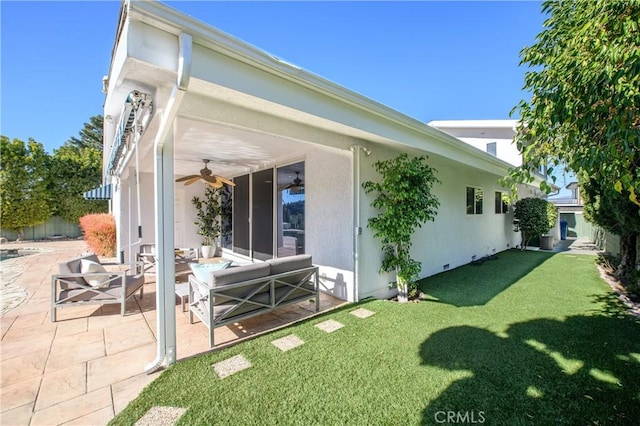 rear view of house with a patio, outdoor lounge area, and a lawn