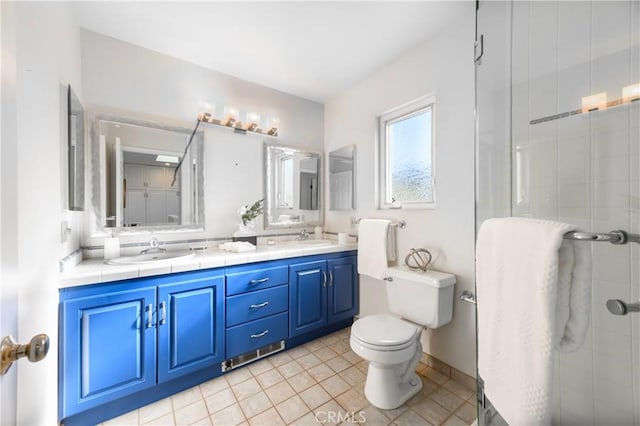 bathroom featuring vanity, toilet, tile patterned floors, and walk in shower