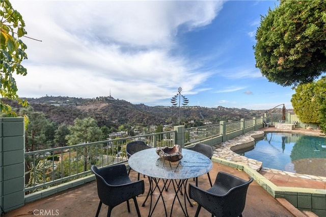 exterior space with a mountain view and a patio area