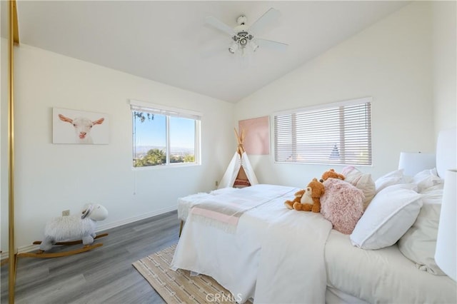 bedroom with hardwood / wood-style flooring, vaulted ceiling, and ceiling fan