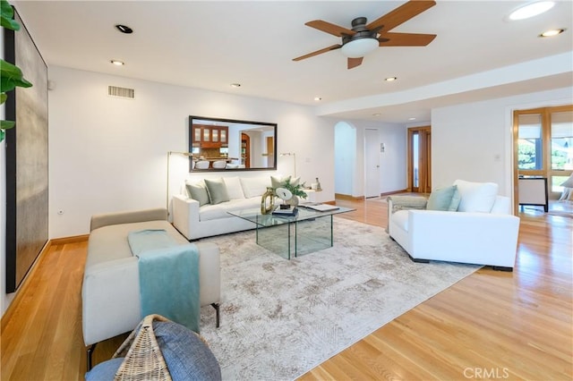 living room with ceiling fan and light hardwood / wood-style floors