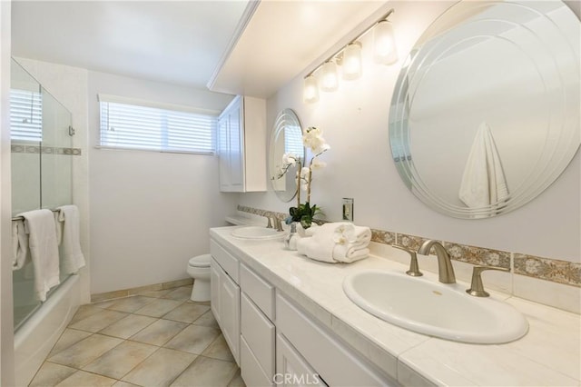 bathroom featuring vanity, tile patterned floors, and toilet