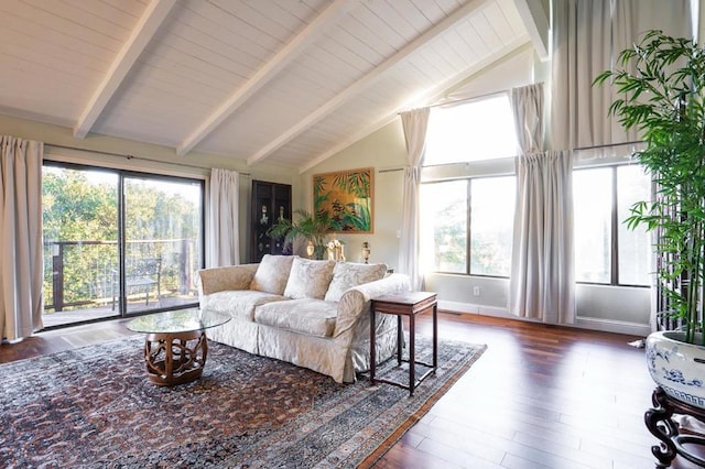 living room featuring a healthy amount of sunlight, vaulted ceiling with beams, and dark hardwood / wood-style floors