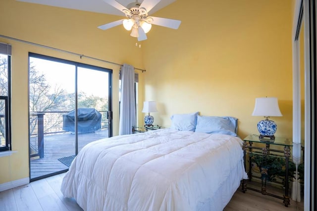 bedroom with ceiling fan, access to outside, and light hardwood / wood-style floors