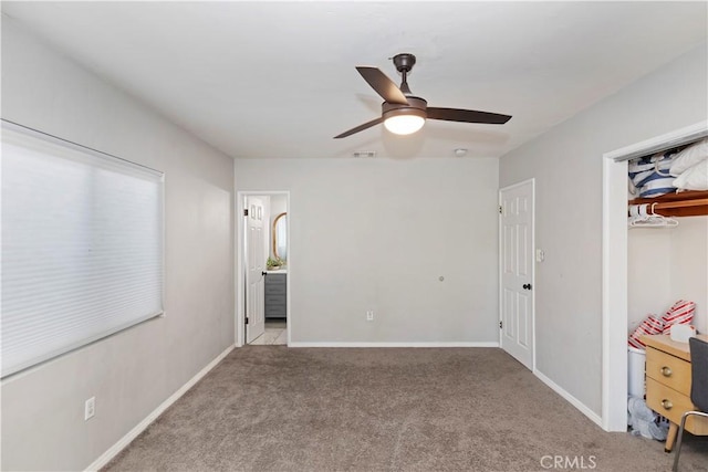 unfurnished bedroom featuring ceiling fan, a closet, and light carpet