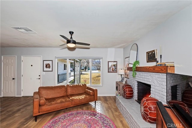 living room with hardwood / wood-style flooring, a fireplace, and ceiling fan