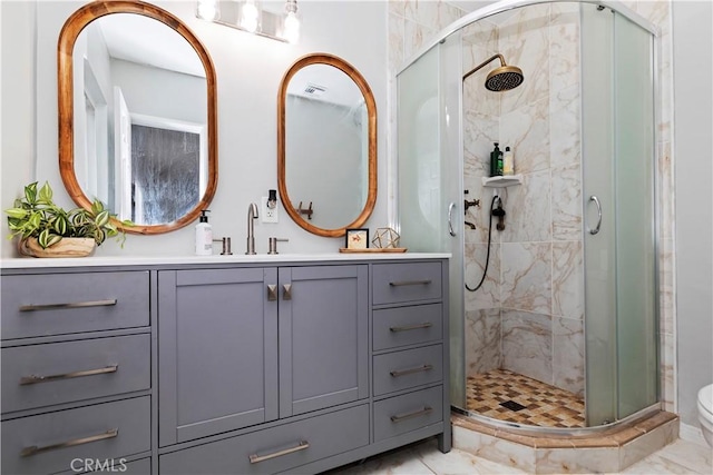 bathroom with vanity and a shower with shower door