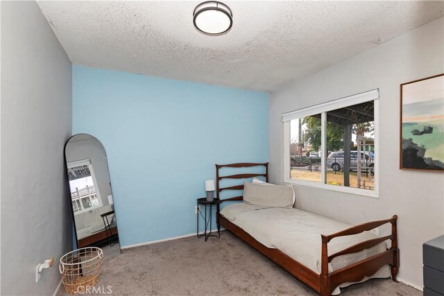 carpeted bedroom with a textured ceiling