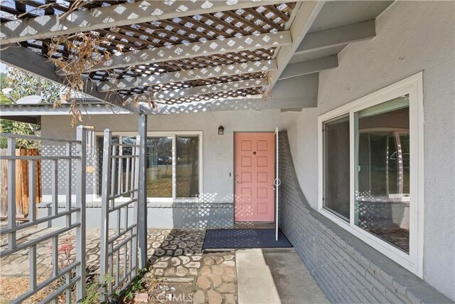 property entrance with a pergola