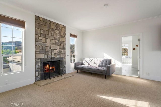 living room featuring crown molding, a mountain view, carpet floors, and a stone fireplace