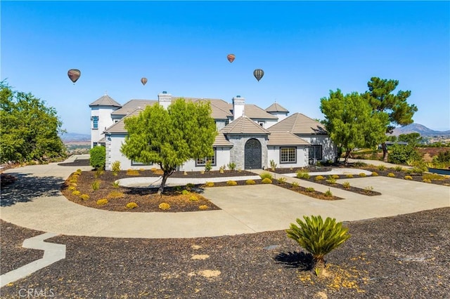 view of front of home with a mountain view and a patio area