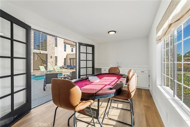 dining space with plenty of natural light and light wood-type flooring