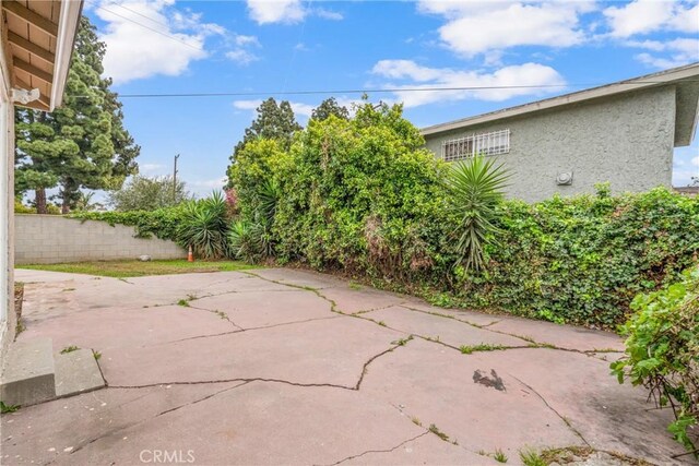 view of patio featuring fence