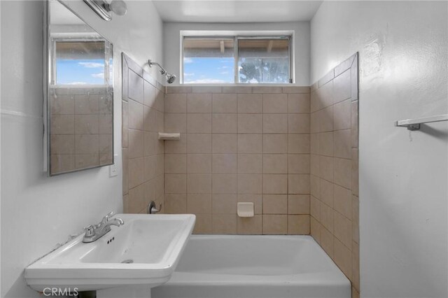 full bath featuring plenty of natural light, bathtub / shower combination, and a sink