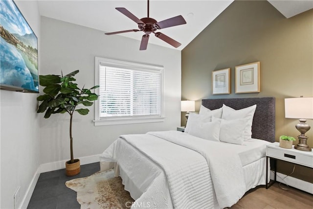 tiled bedroom with lofted ceiling and ceiling fan