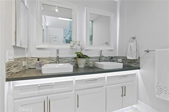 bathroom with vanity and decorative backsplash