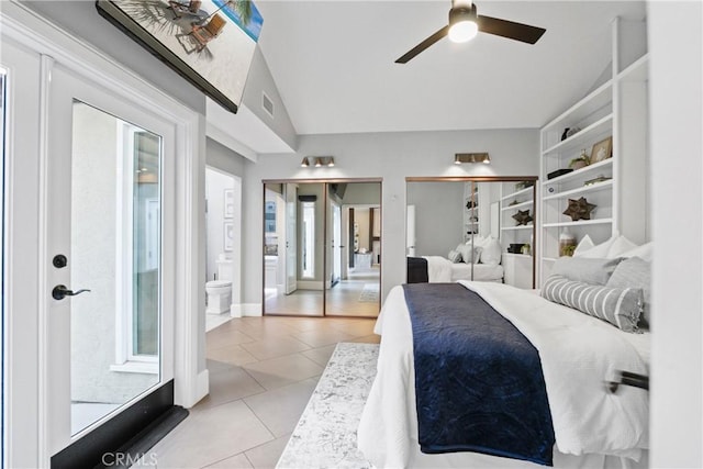 tiled bedroom featuring lofted ceiling, ceiling fan, and ensuite bathroom