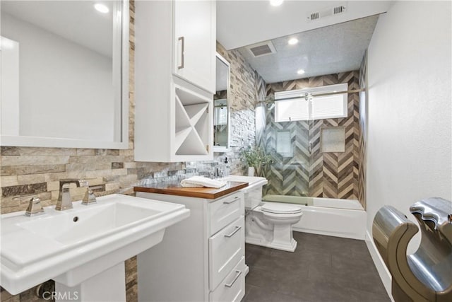 full bathroom with bathing tub / shower combination, sink, and toilet