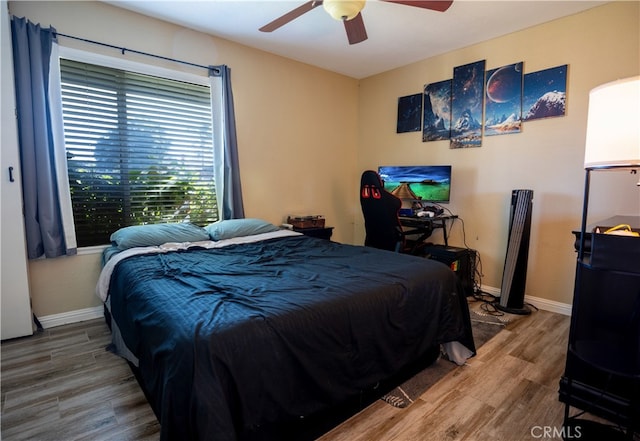 bedroom with wood-type flooring and ceiling fan