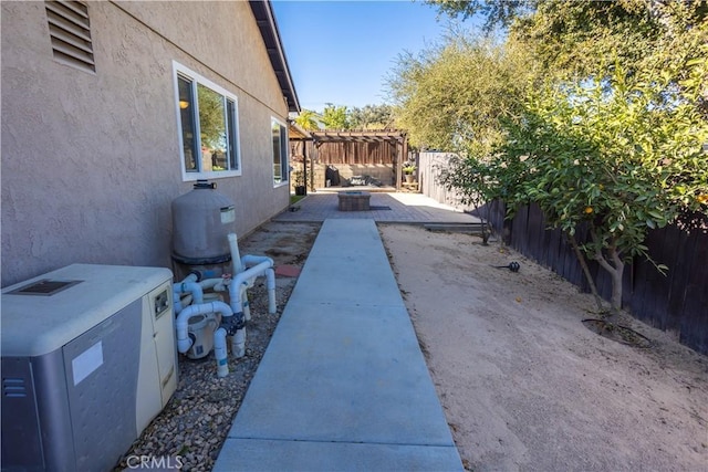 exterior space featuring a patio and an outdoor fire pit