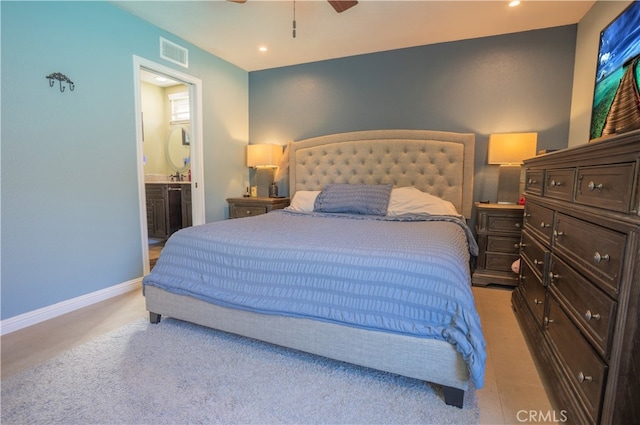 carpeted bedroom featuring ensuite bathroom and ceiling fan