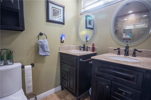 bathroom with vanity, tile patterned flooring, and toilet